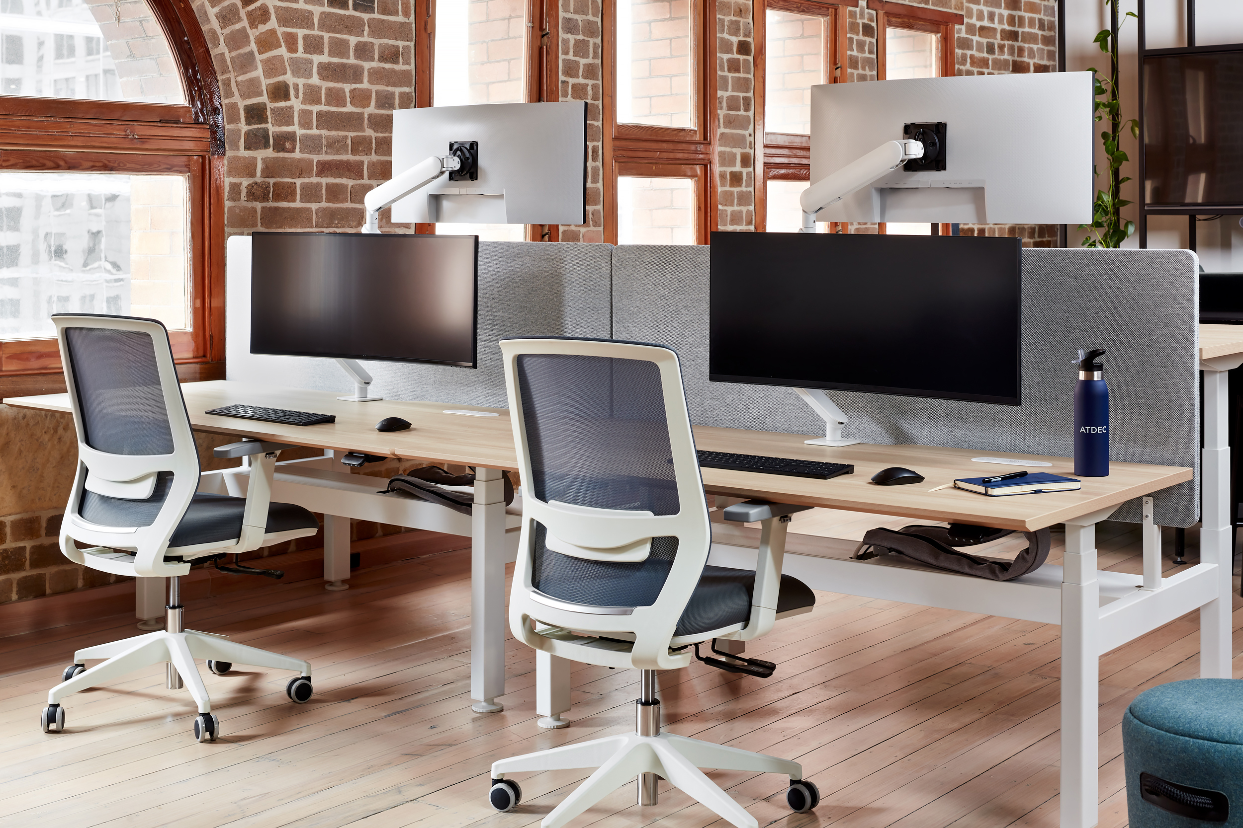 Atdec desk mounts in workspace